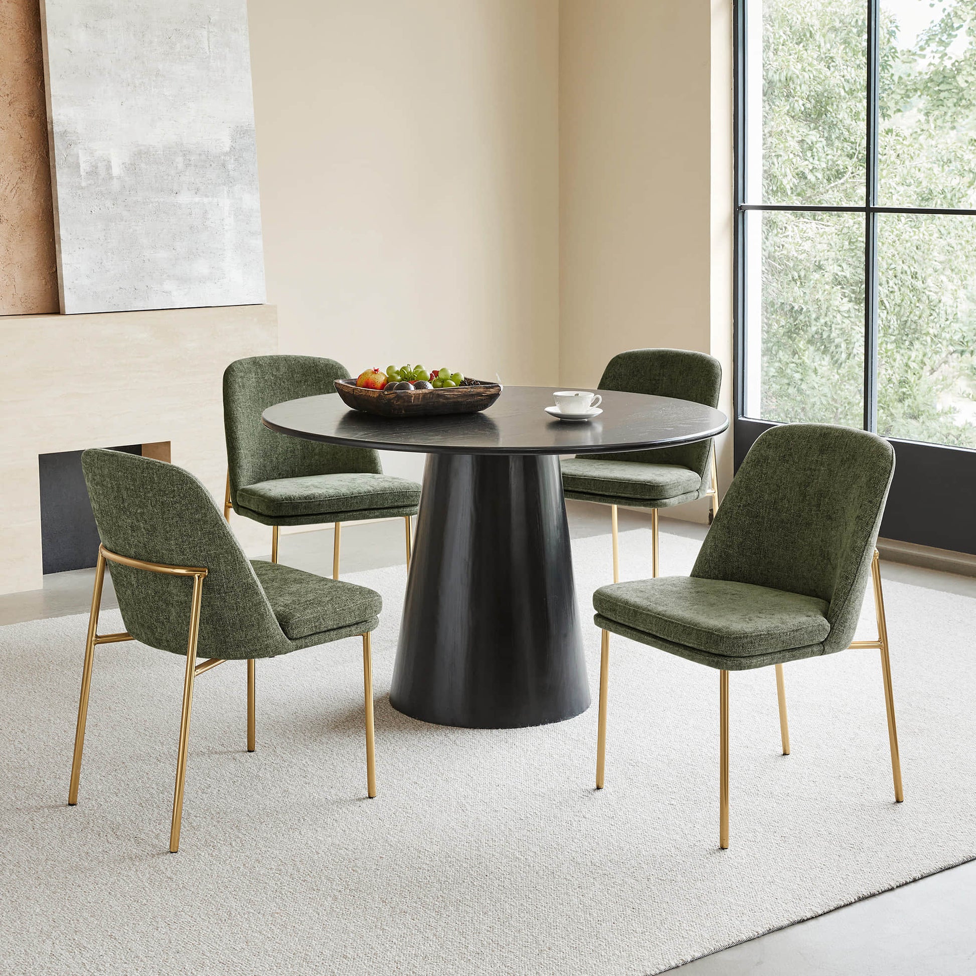 Golda Dining Chair, green fabric with gold legs, set around a modern dining table in a bright room.