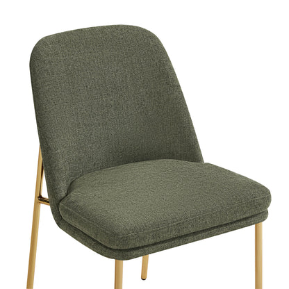 Golda Dining Chair, green fabric with gold legs, close-up of seat and backrest from a side angle.