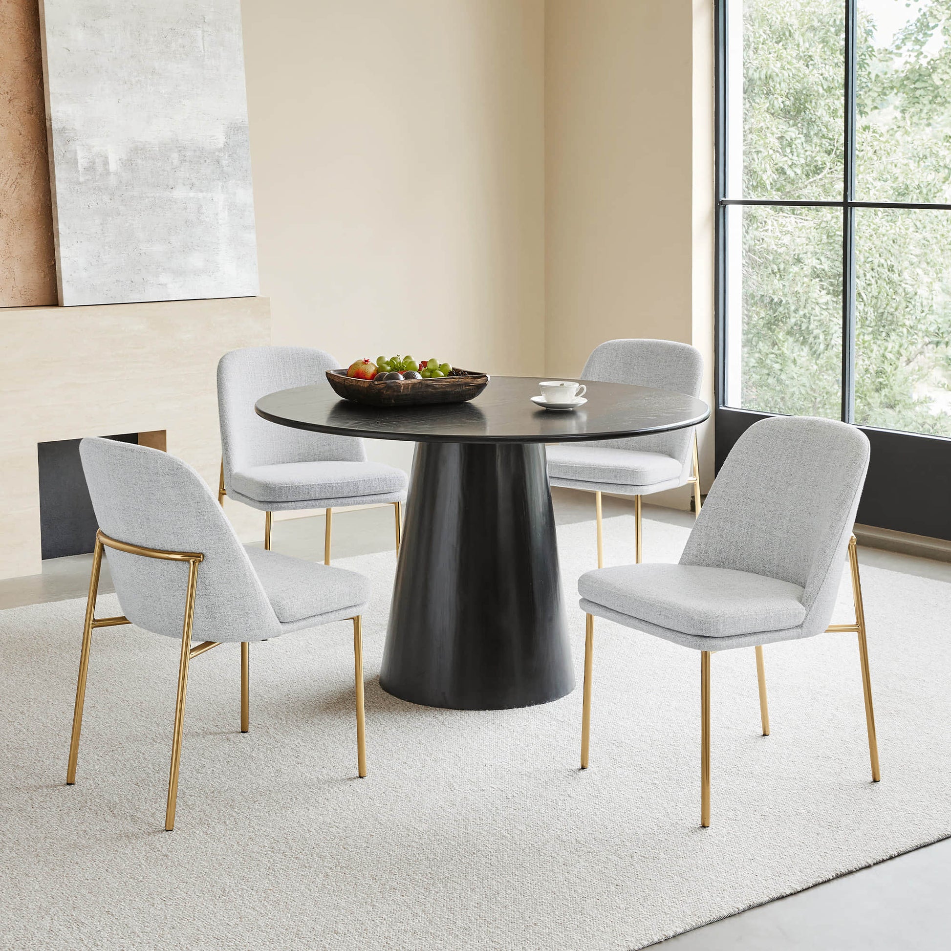 Golda Dining Chair, light gray fabric with gold legs, modern dining room with round table.