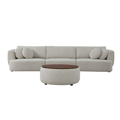 Grace modular curved sofa in light boucle fabric with round cushions and walnut ottoman.