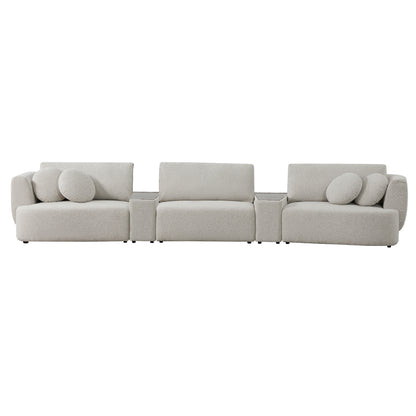 Grace modular curved sofa in light boucle with round cushions in modern living room.