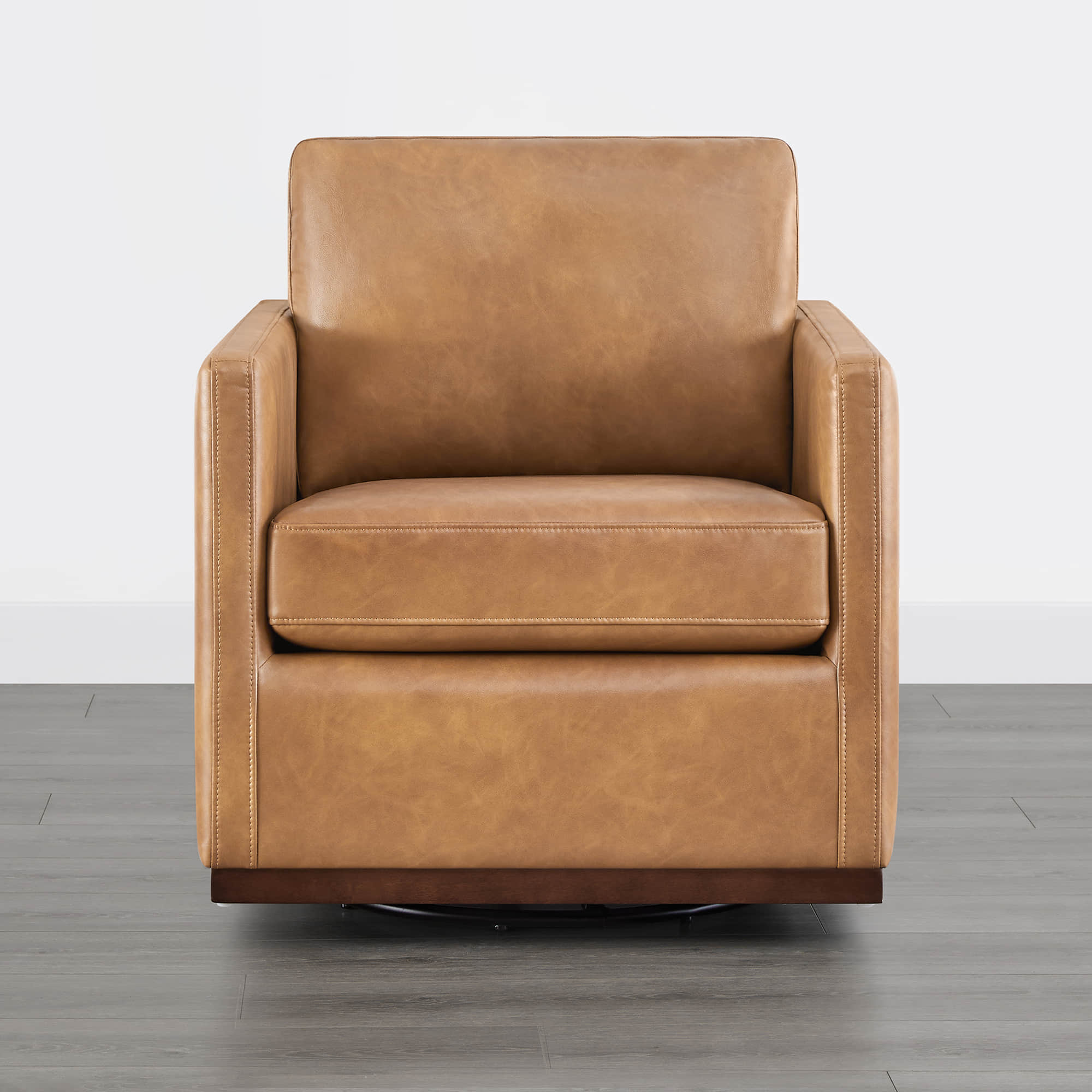 Tan leather Henry Modern Swivel Accent Chair with wooden base in minimalist setting - CHITA Living