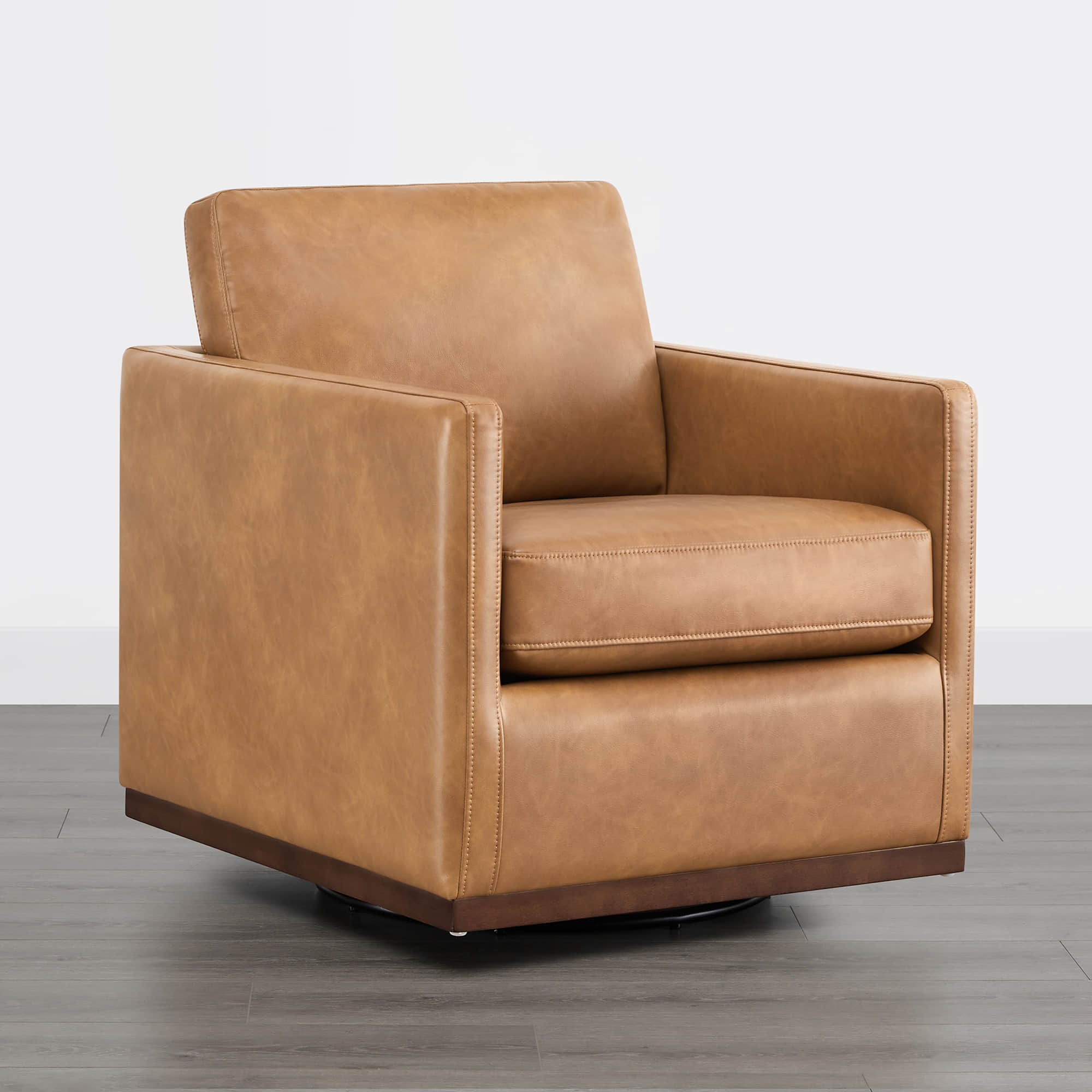 Tan leather Henry Modern Swivel Accent Chair with wooden base in minimalist setting - CHITA Living