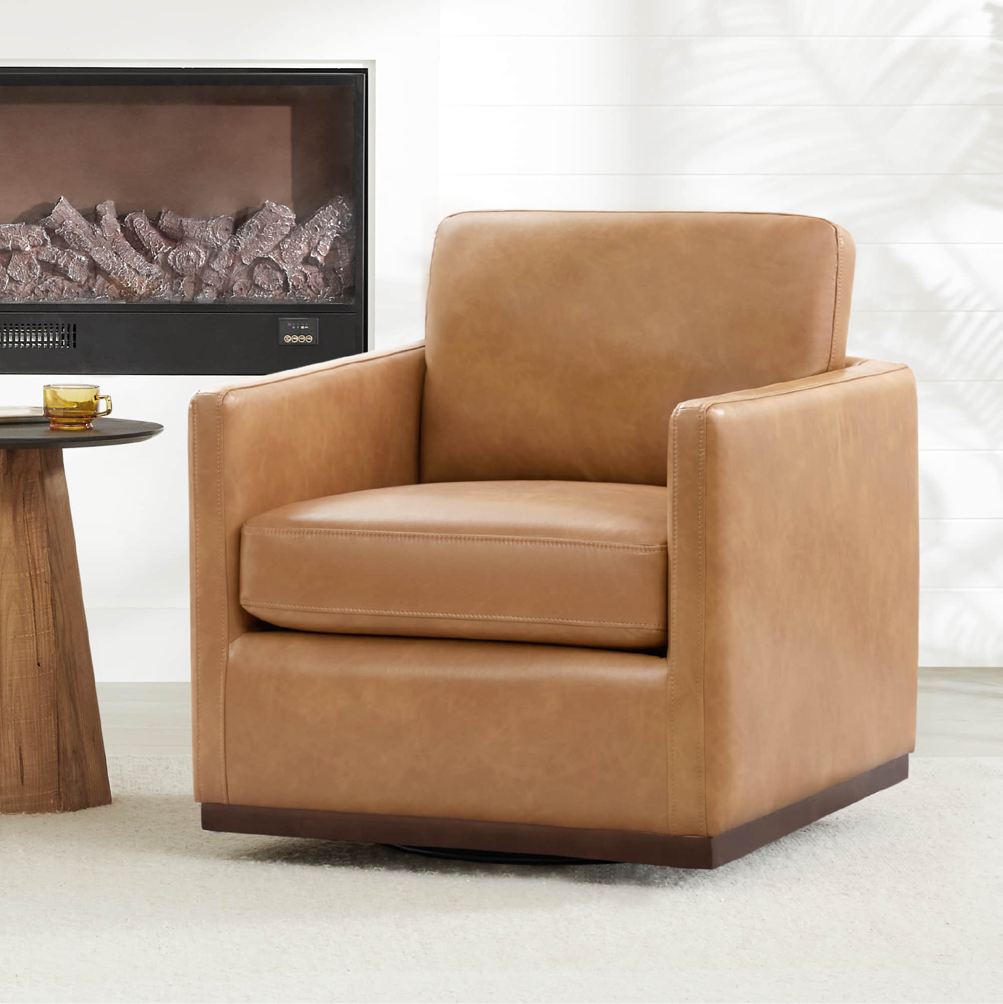 Tan leather Henry Modern Swivel Accent Chair on a wooden base in a stylish living room - CHITA Living