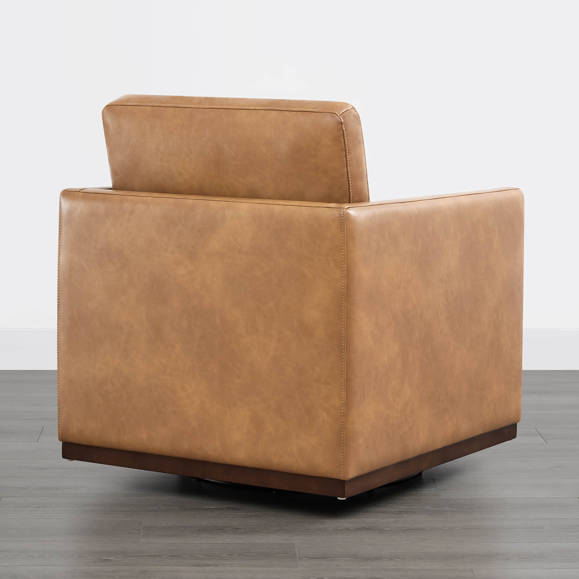 Back view of Henry Modern Swivel Accent Chair in tan leather with wooden base - CHITA Living