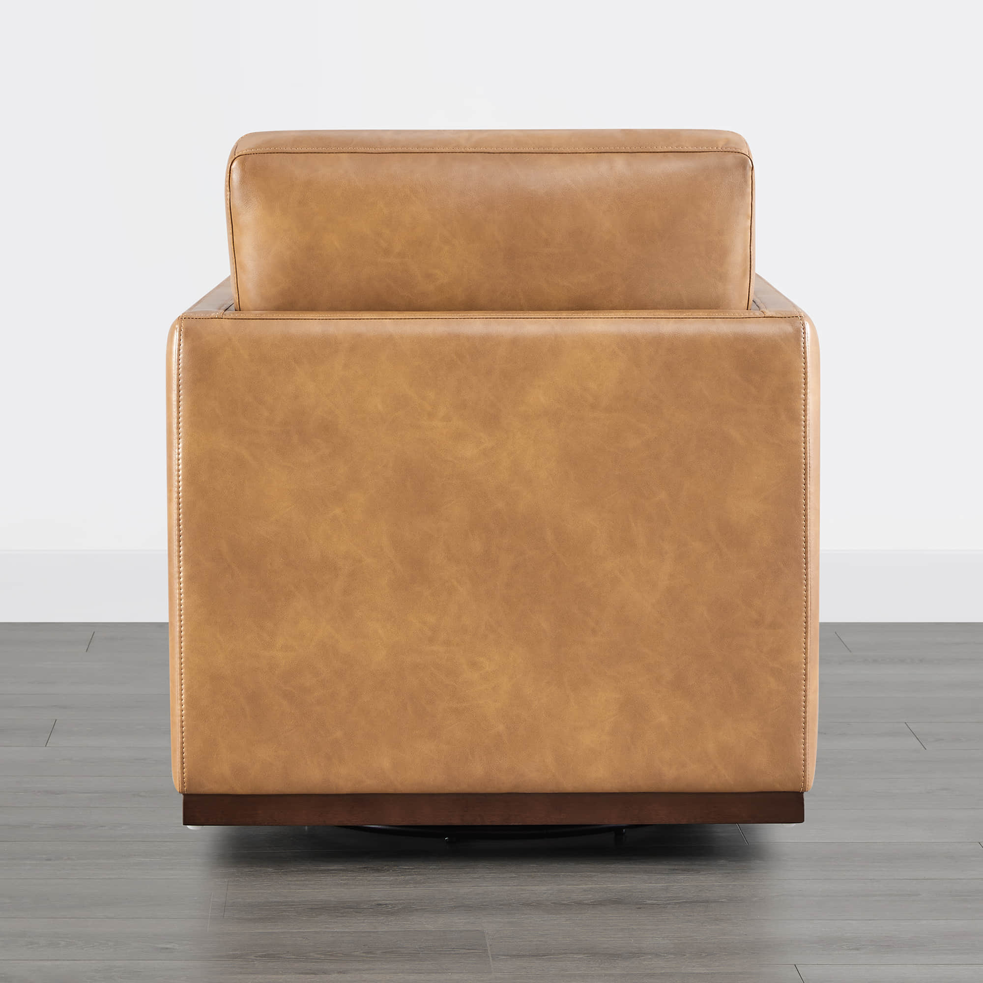 Back view of tan leather Henry Modern Swivel Accent Chair with wooden base - CHITA Living