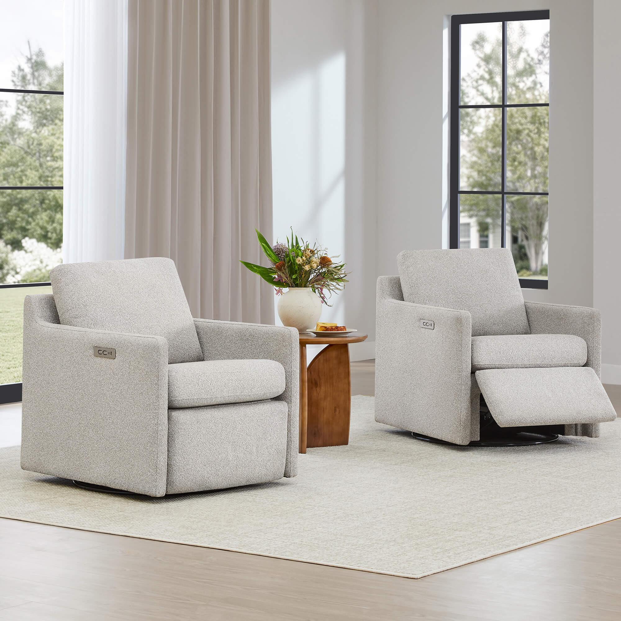 Two Henry Power Swivel Recliners in light beige fabric, one with footrest extended