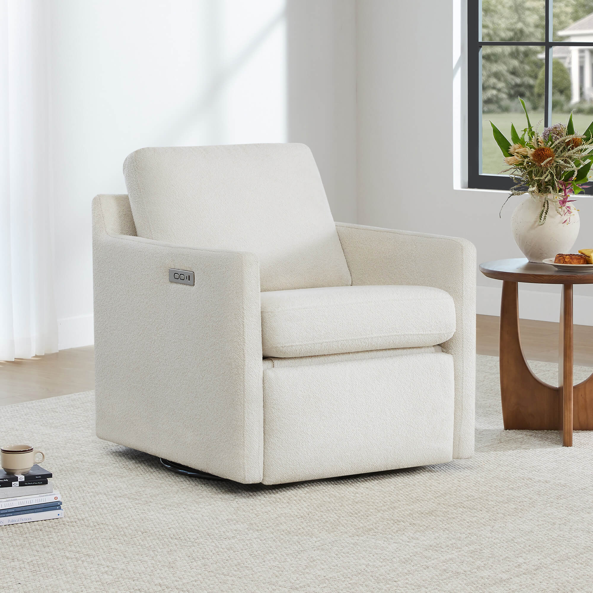 Henry Power Swivel Recliner in light beige fabric, positioned in a cozy living room.