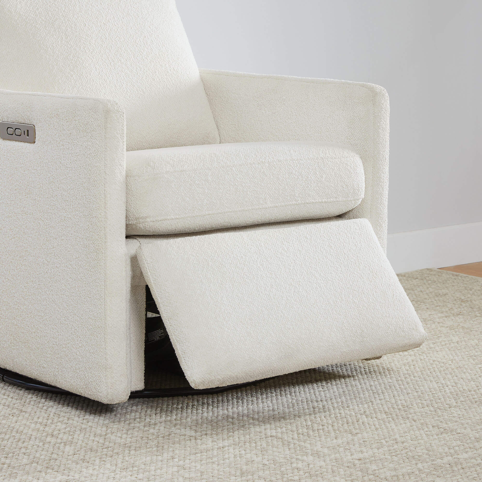 Henry Power Swivel Recliner in light beige fabric, close-up of footrest extended.