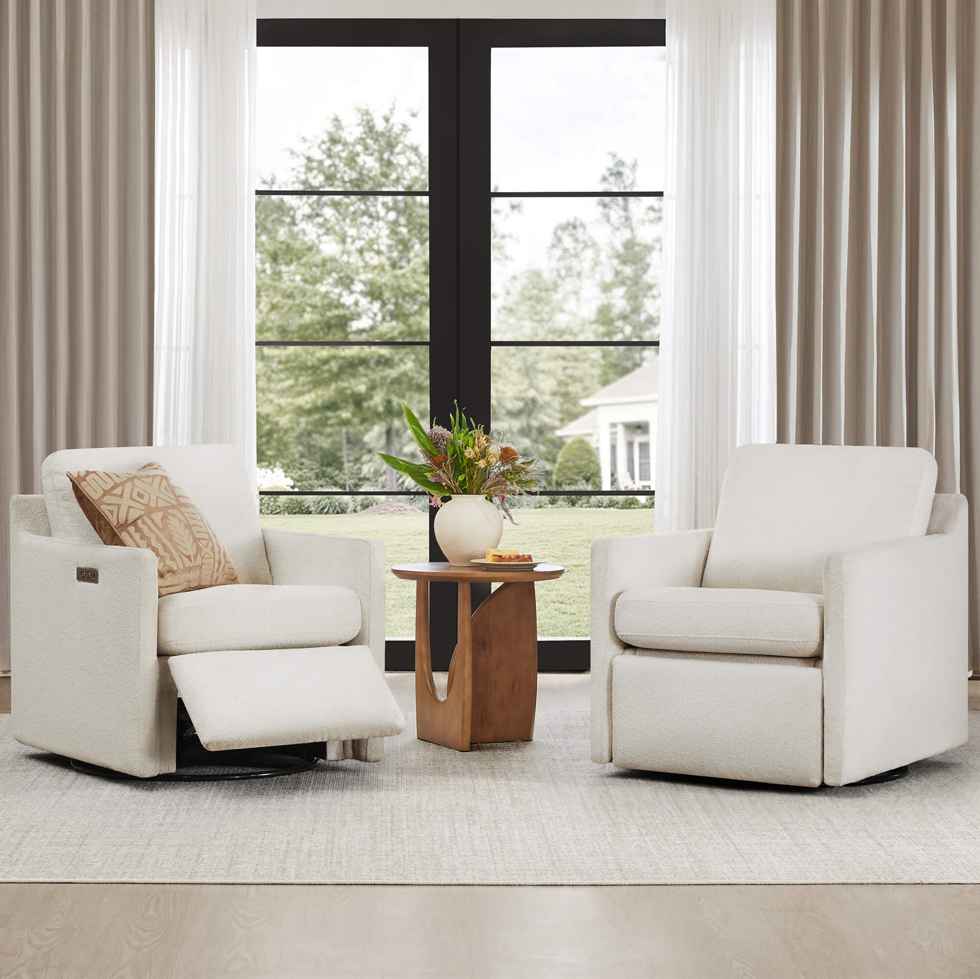 Two Henry Power Swivel Recliner chairs in a bright room with a large window.