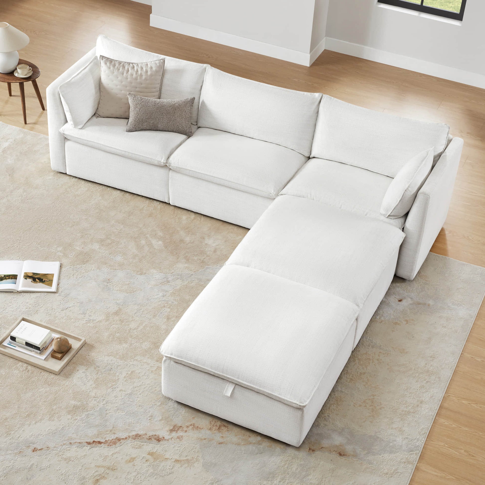 Sophia feather modular sofa in bright room with round coffee table and soft rug - CHITA Living