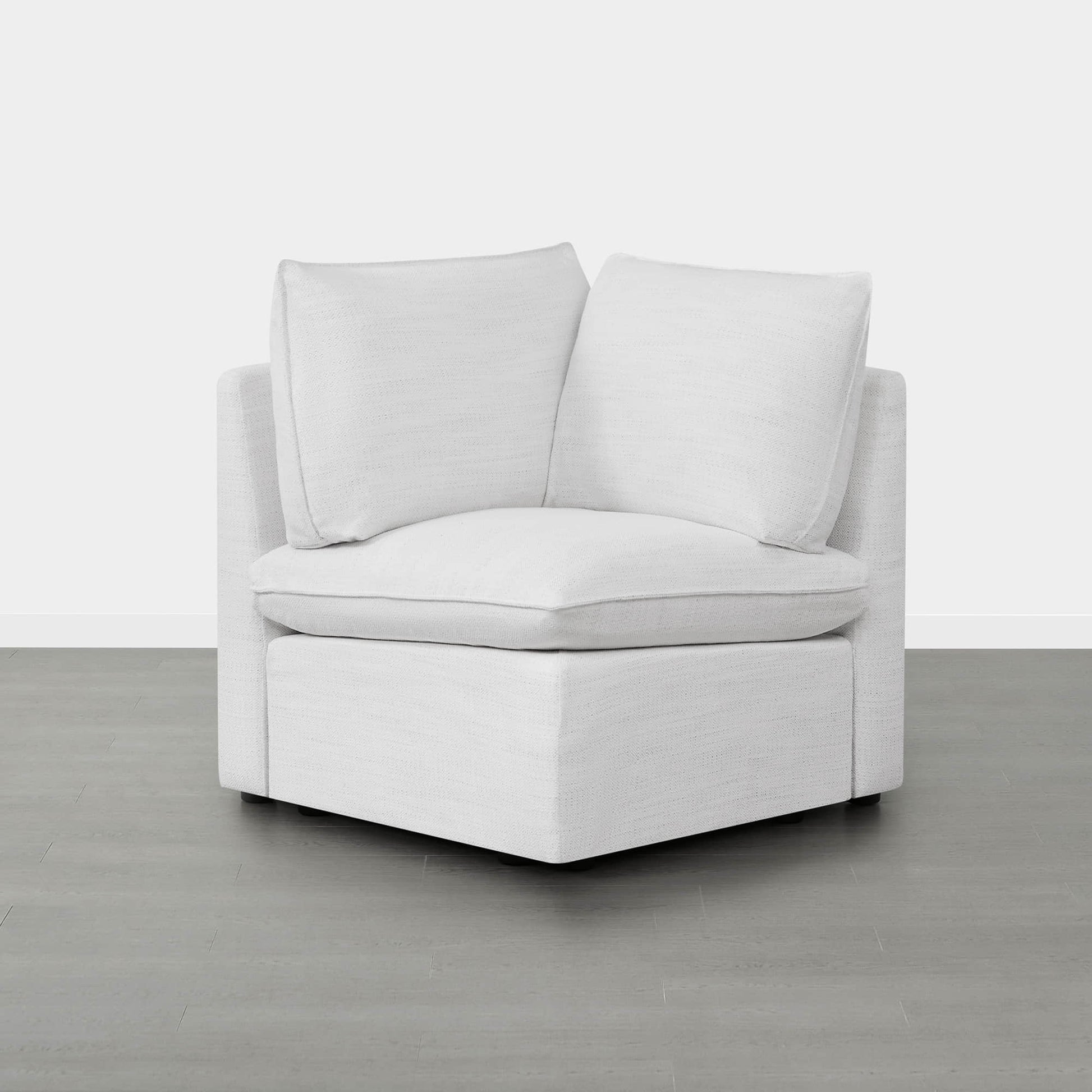 Sophia modular sofa corner piece with plush white cushions in minimalistic room.