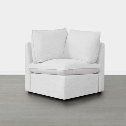 Sophia modular sofa corner piece with plush white cushions in minimalistic room - CHITA Living