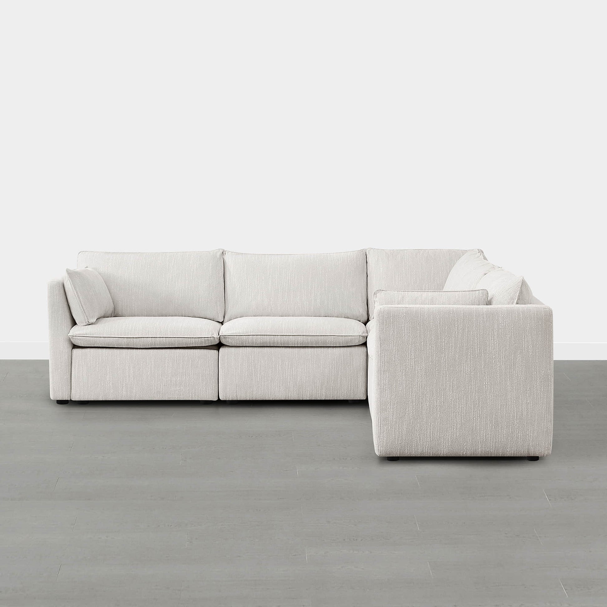 Sophia 5-piece feather modular sofa in light beige fabric against a minimalist gray backdrop.