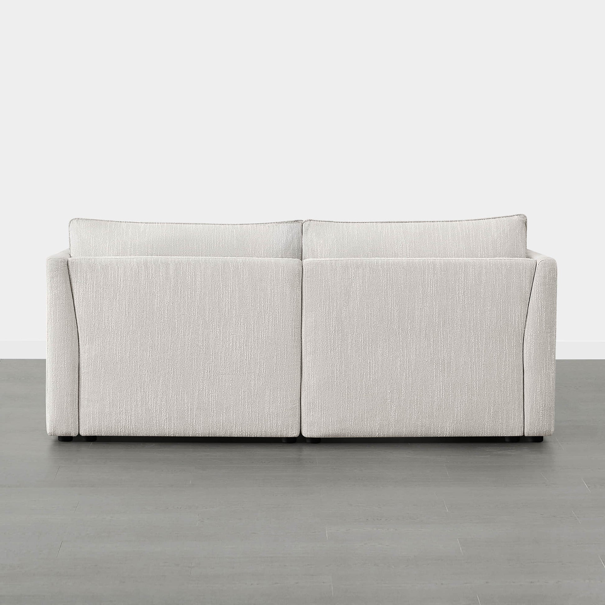 Back view of Sophia 2-piece modular sofa showcasing its minimalist style and light fabric - CHITA Living