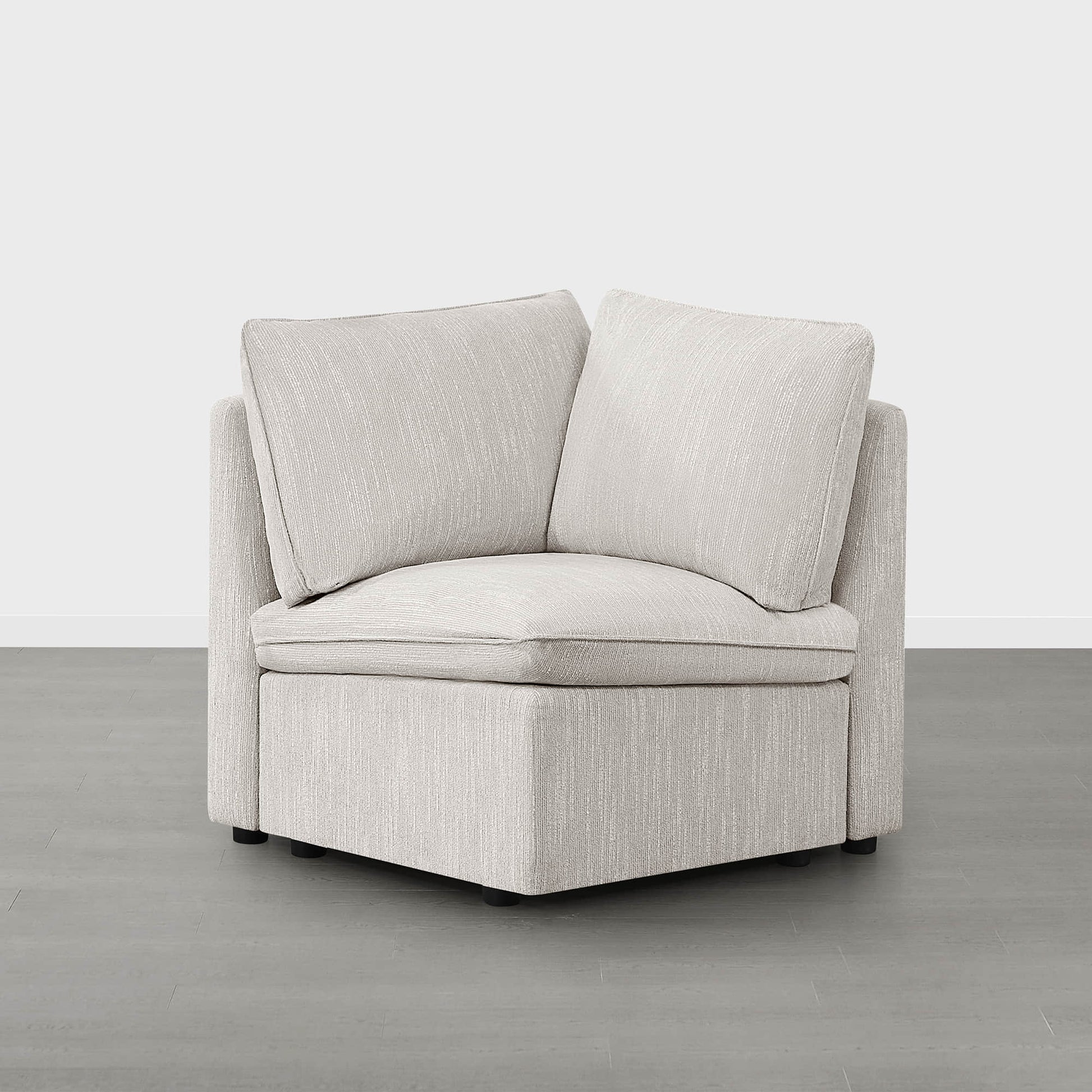 Sophia modular sofa corner piece with light beige fabric in minimalist living space.