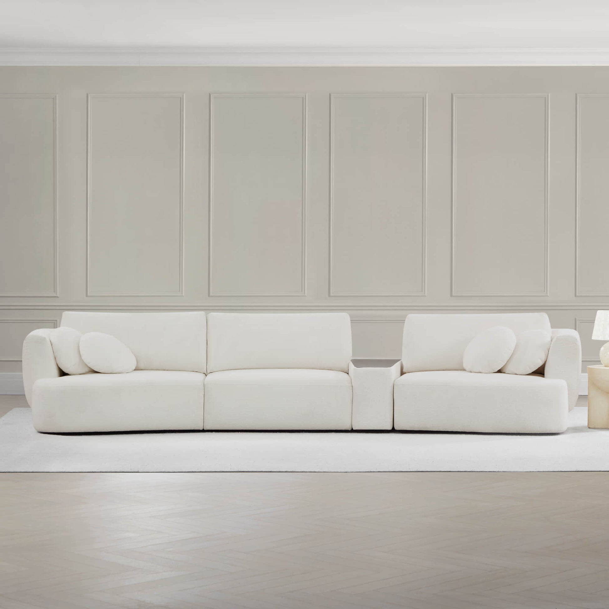 Grace 3-Seat Modular Curved Sofa in light fabric with round cushions in a bright space.