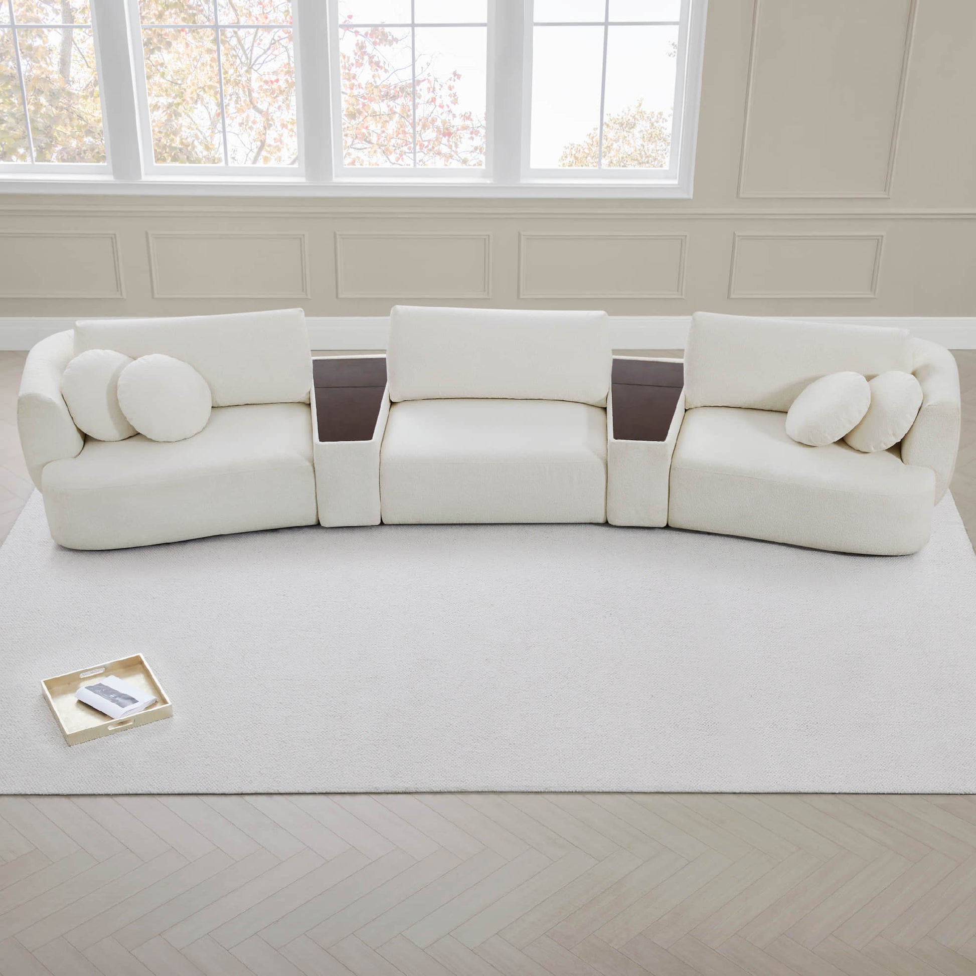 Grace 3-Seat Modular Curved Sofa in light fabric with rounded cushions in bright room.