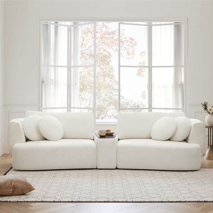 Curved white Grace modular sofa with round cushions in a light-filled modern space - CHITA Living