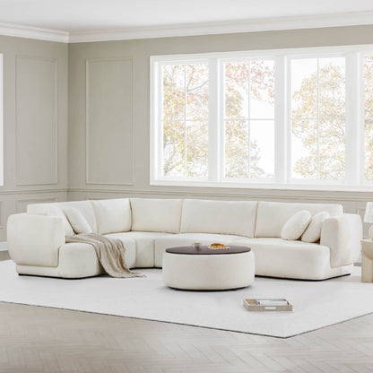 Light fabric Grace modular curved sofa with cozy cushions in airy living room - CHITA Living