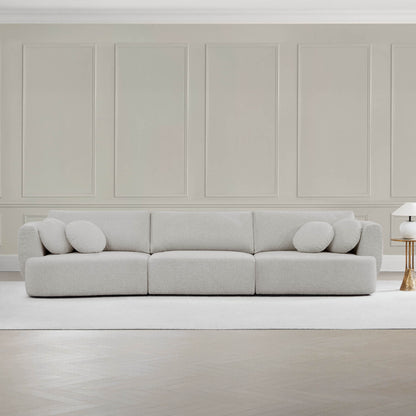 Grace 3-Seat Modular Curved Sofa in light fabric with round cushions in modern living room.