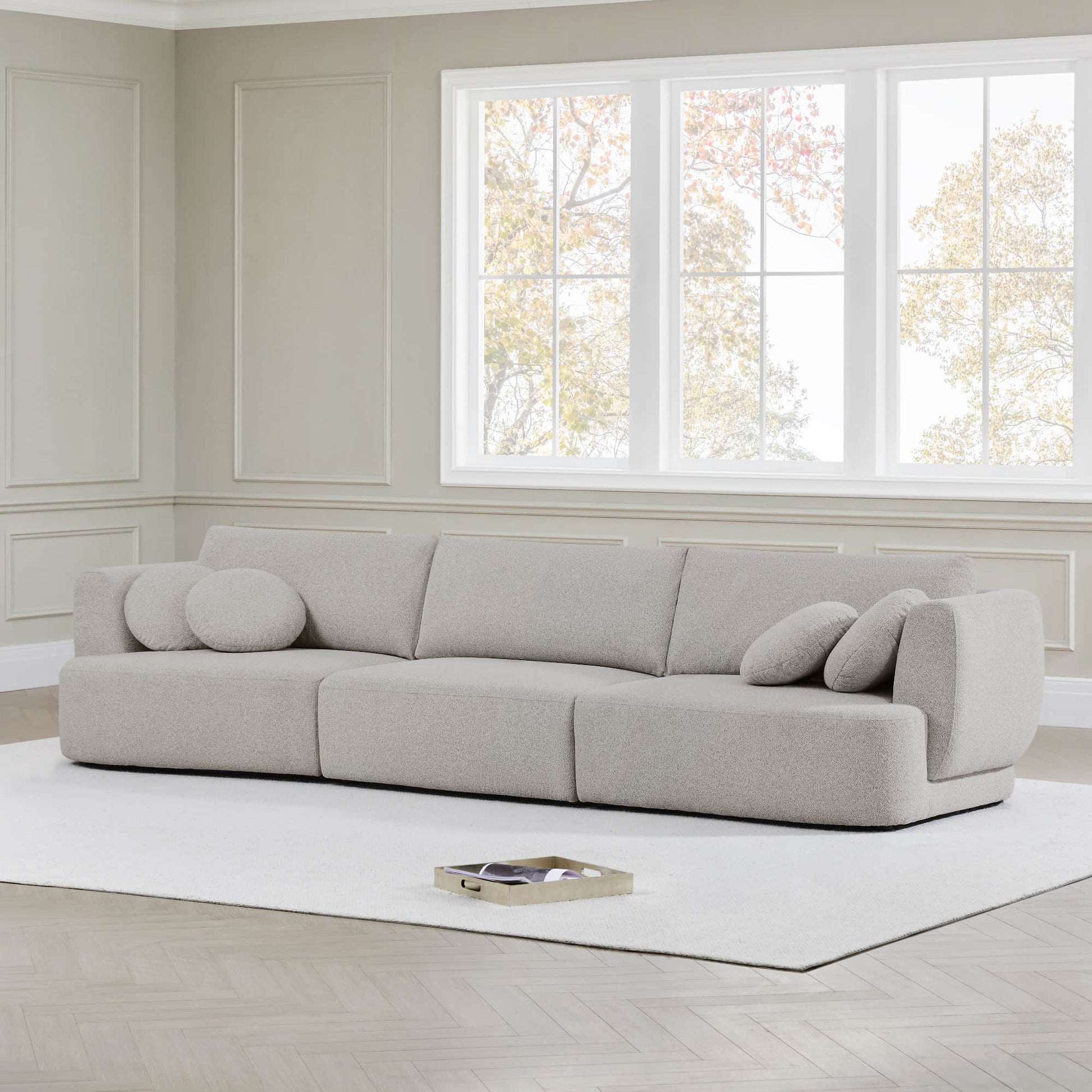 Grace modular curved sofa in light boucle fabric with round cushions in modern living room - CHITA Living