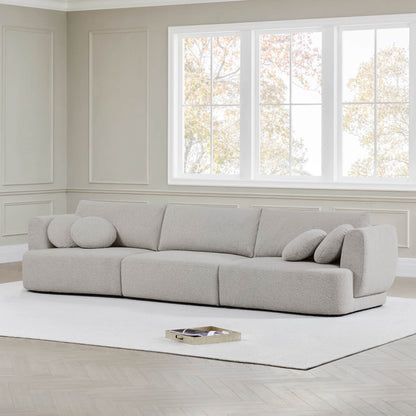 Grace modular curved sofa in light boucle fabric with round cushions in modern living room - CHITA Living