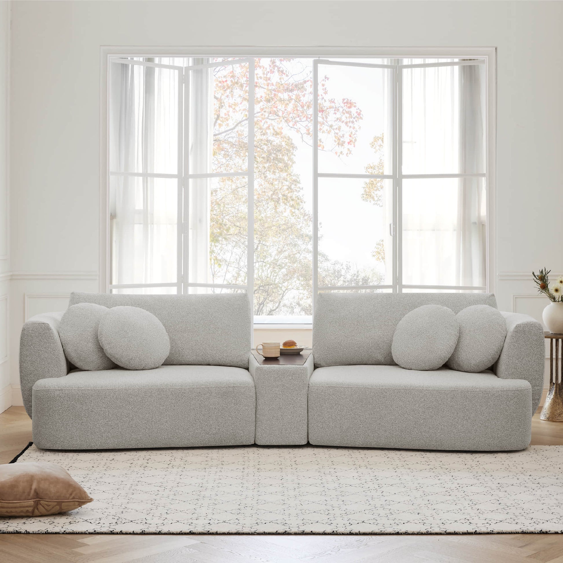 Grace 2-seat modular curved gray sofa with round cushions in a bright living room - CHITA Living