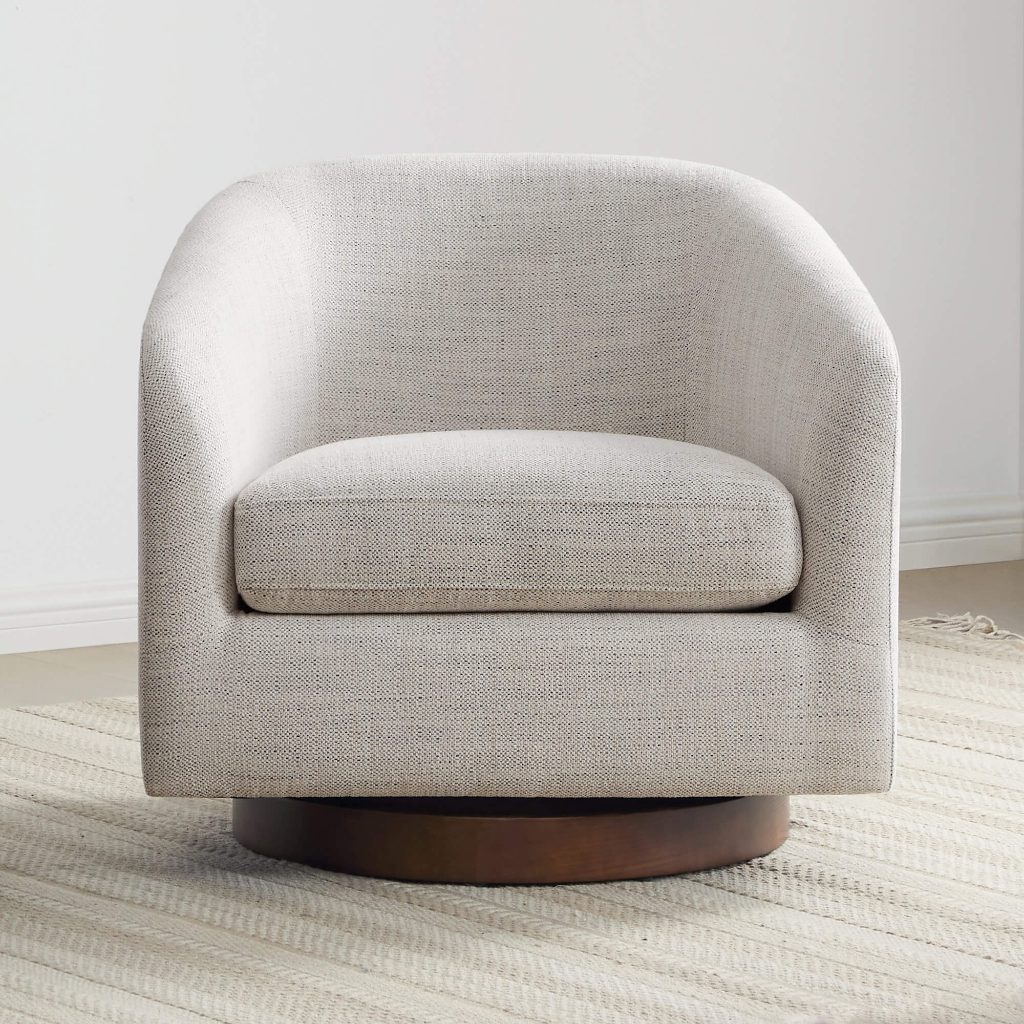 Beige Wren Modern Swivel Accent Chair with rounded design on textured rug - CHITA Living