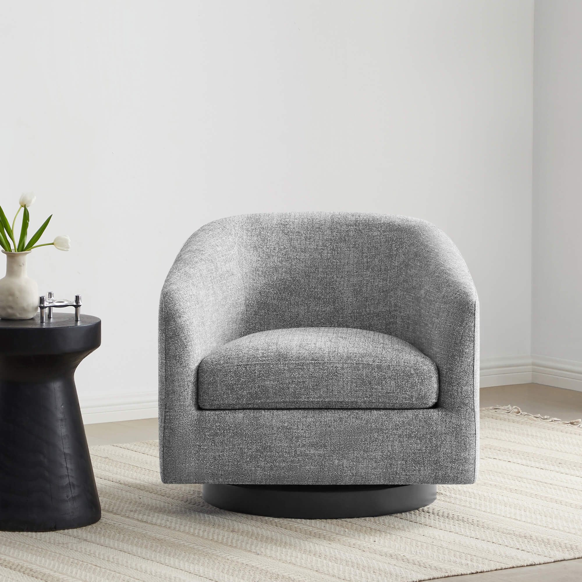 Gray Wren Modern Swivel Accent Chair with plush seat next to a black side table and rug - CHITA Living