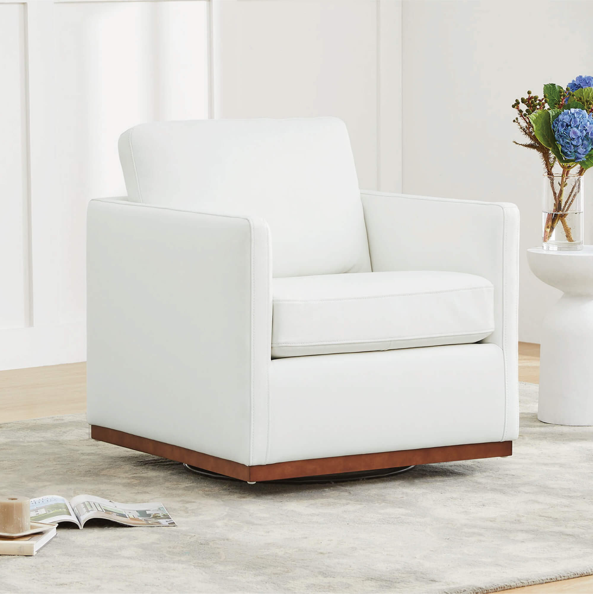 White Henry Modern Swivel Accent Chair with wooden base in a minimalist living room - CHITA Living