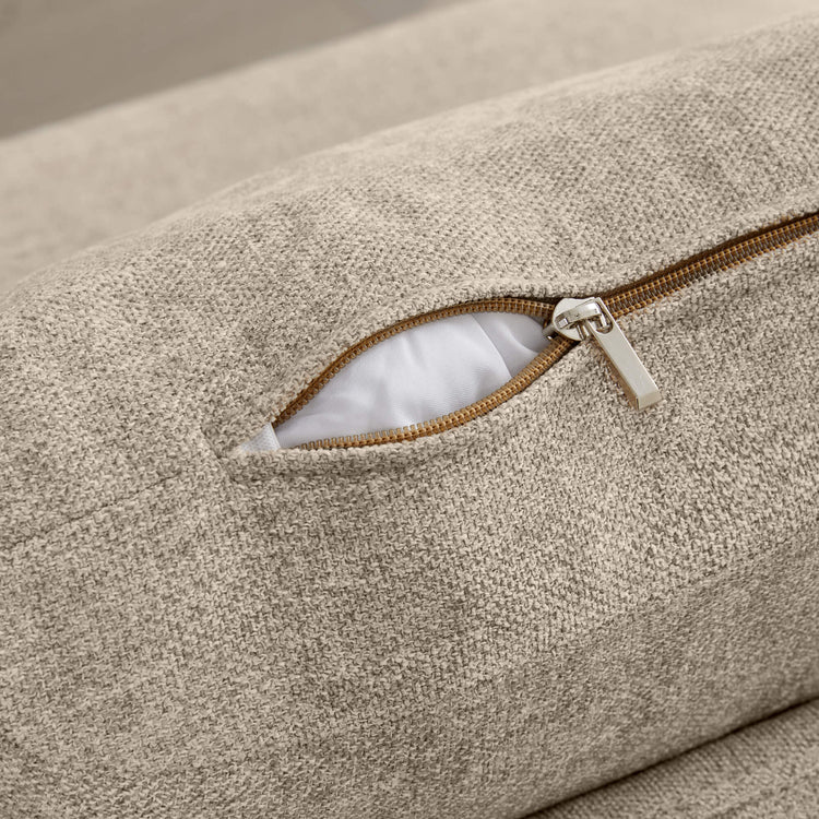 Beige textured fabric on Lila corner seat, revealing open storage compartment with silver zipper.