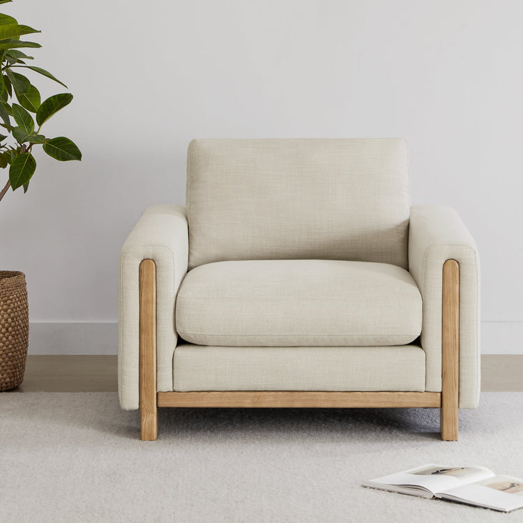 Keaton Wood Base Armchair with soft cushions and natural wood base in a stylish setting - CHITA Living
