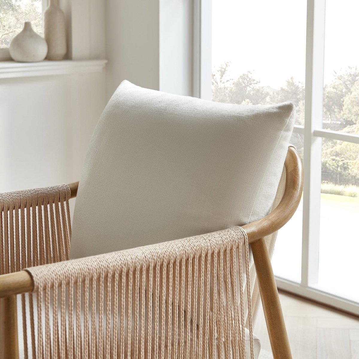 Sienna Modern Braid Chair close-up with cream cushion and braided backrest in bright room - CHITA Living