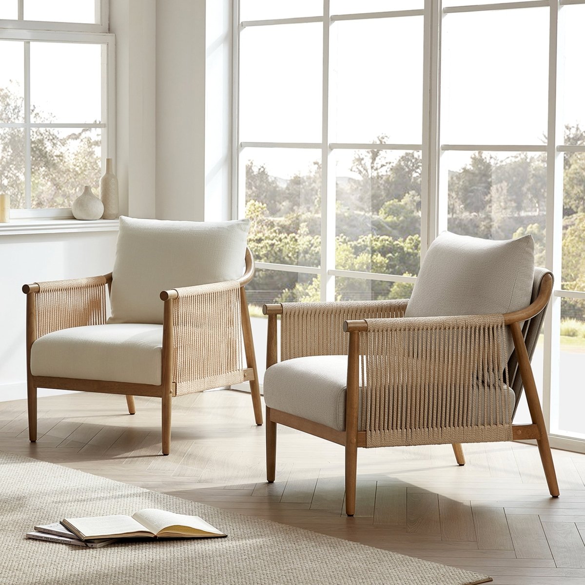 Pair of stylish braided armchairs with cream cushions in a sunlit living room - CHITA Living