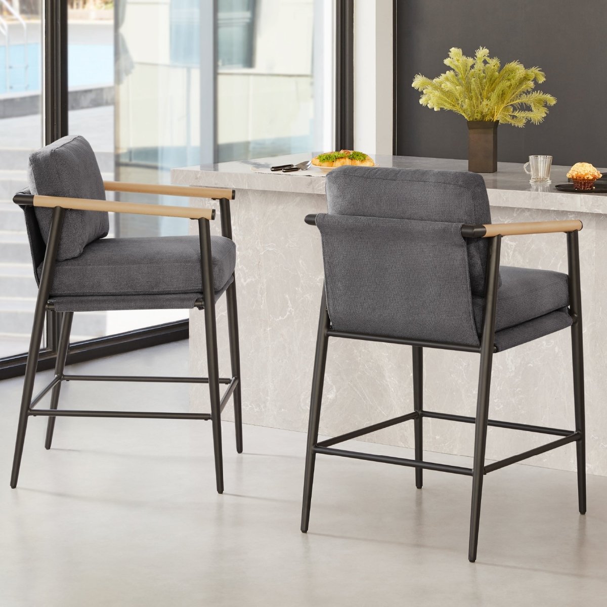 Charlotte Modern Counter Stools with gray fabric seats and wooden armrests in bright kitchen - CHITA Living