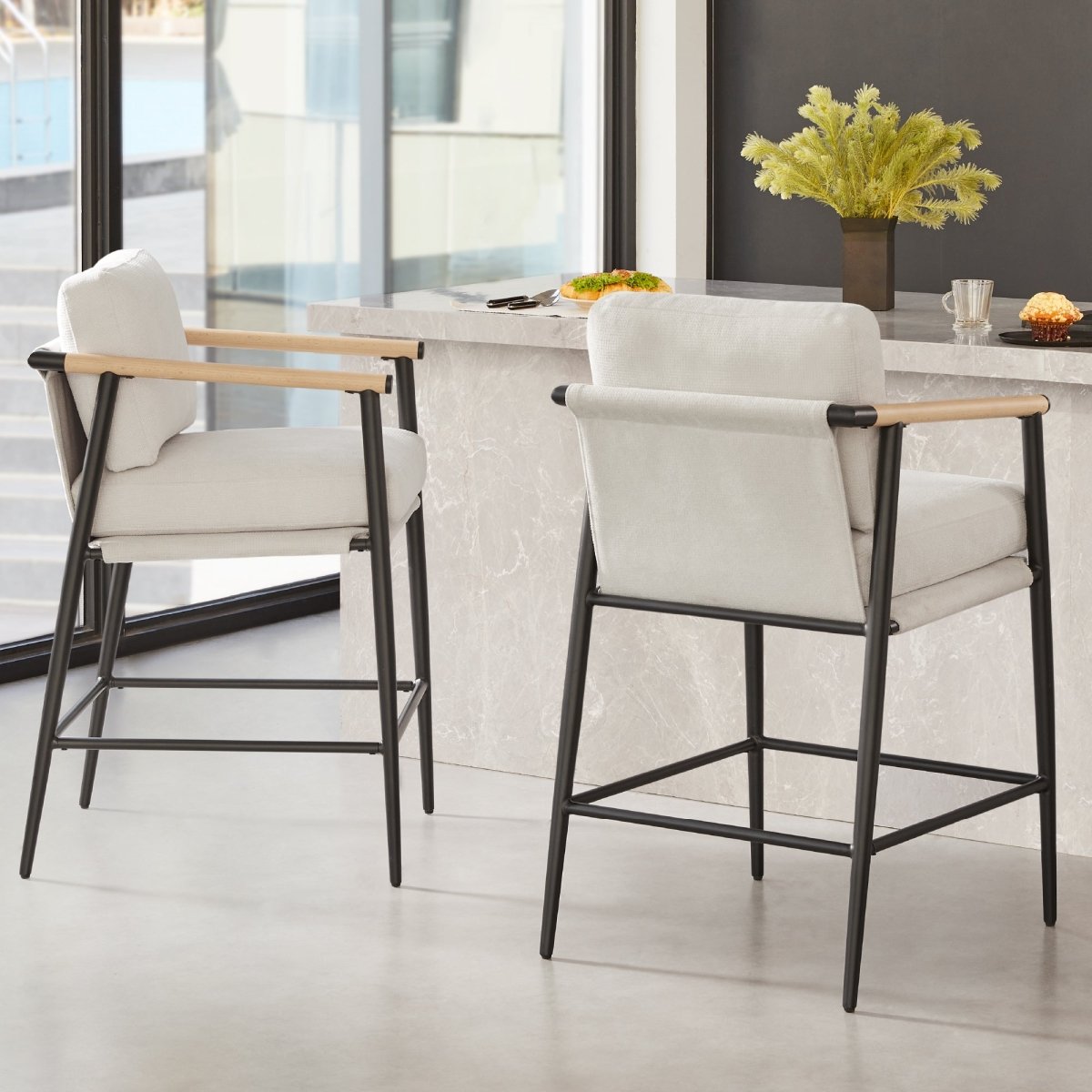 Charlotte Modern Counter Stool in light gray fabric with wood armrests in a modern kitchen - CHITA Living