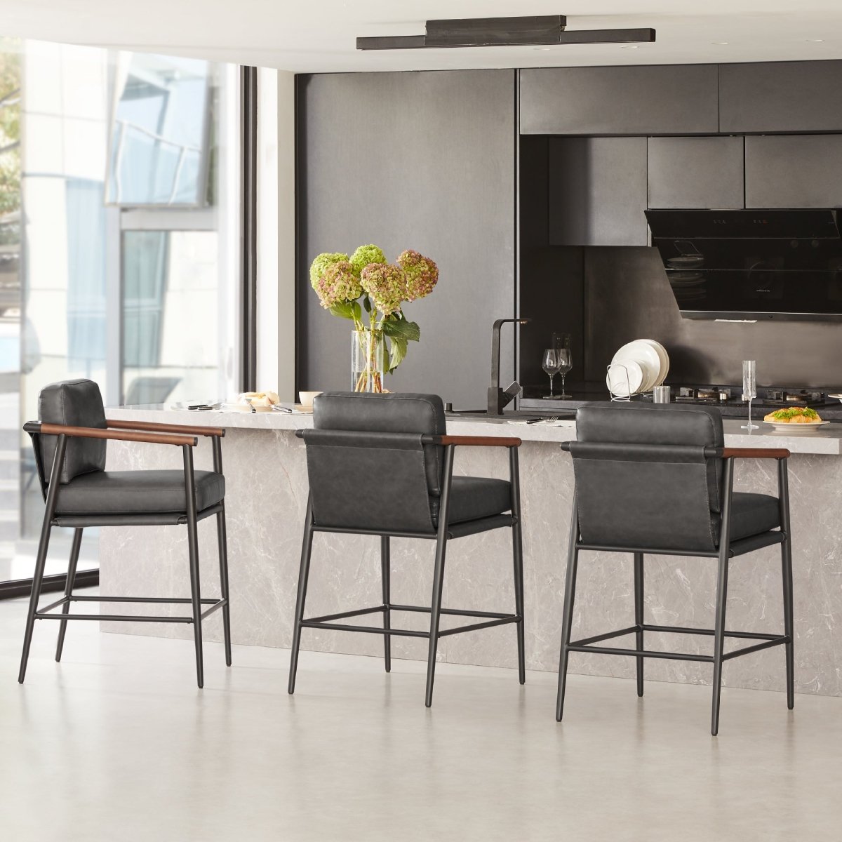 Charlotte Modern Counter Stool with black leather seats and wooden armrests in sleek kitchen - CHITA Living