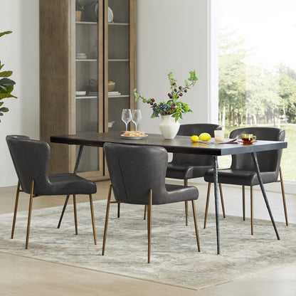 Golda Dining Chairs in grey faux leather with brass legs around a modern dark dining table - CHITA Living