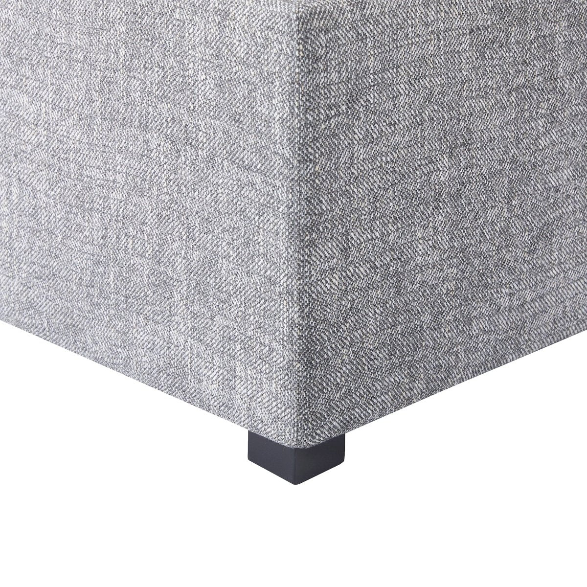 Corner of gray cube storage ottoman with textured fabric and black leg - CHITA Living