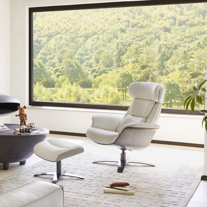 White leather Elvin recliner and ottoman in modern living room with window view - CHITA Living