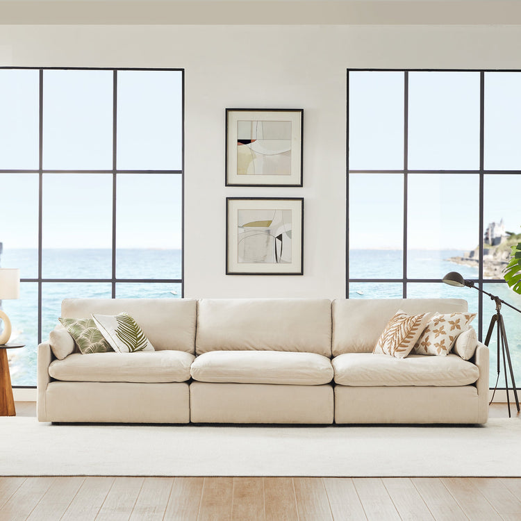 Kenna 3 Seat Modular Sofa in beige fabric with ocean view. Comfortable, deep seat, and soft cushions.