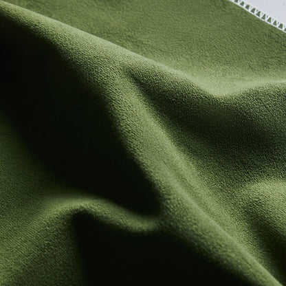 Close-up of soft green velvet fabric swatch for stylish pet-friendly furniture.