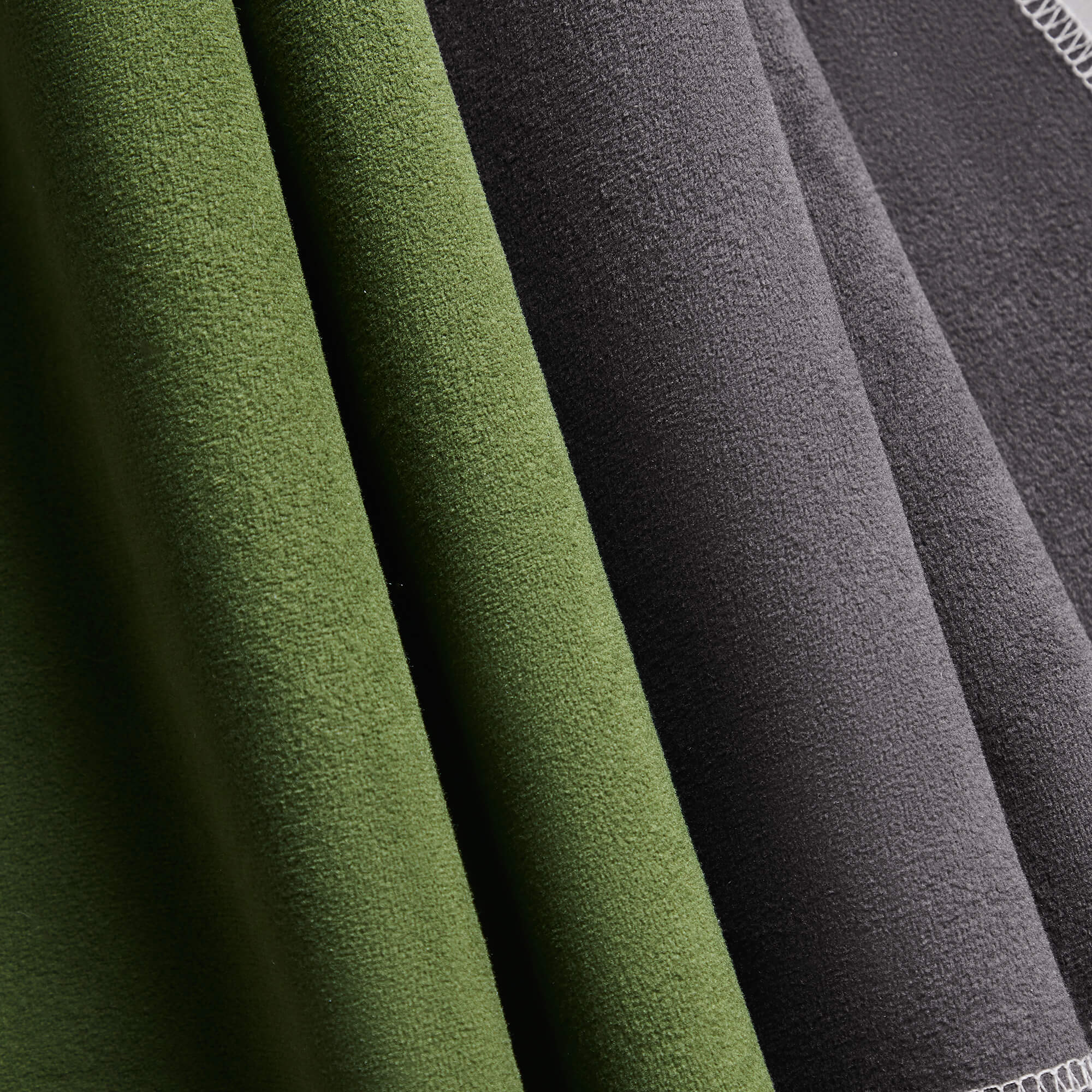 Pet-friendly velvet swatches in dark green and charcoal gray for stylish furniture.